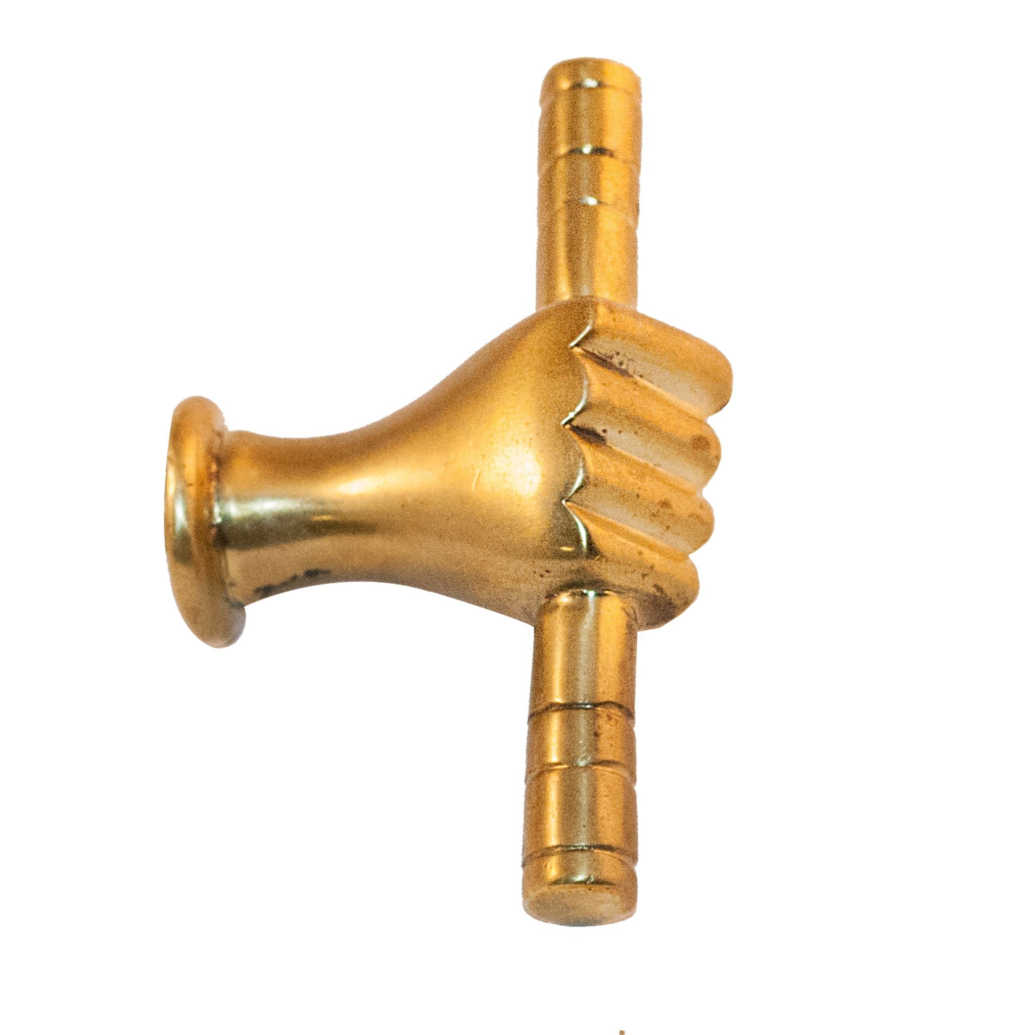 An image of a brass hand-shaped knob against a neutral background. The knob depicts detailed hand designs, adding a unique and artistic touch to furniture or drawers.