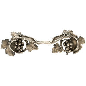 An image of a brass knob shaped like clusters of grapes against a neutral background. The knob features intricate detailing resembling grape clusters, adding a touch of rustic charm to furniture or drawers.