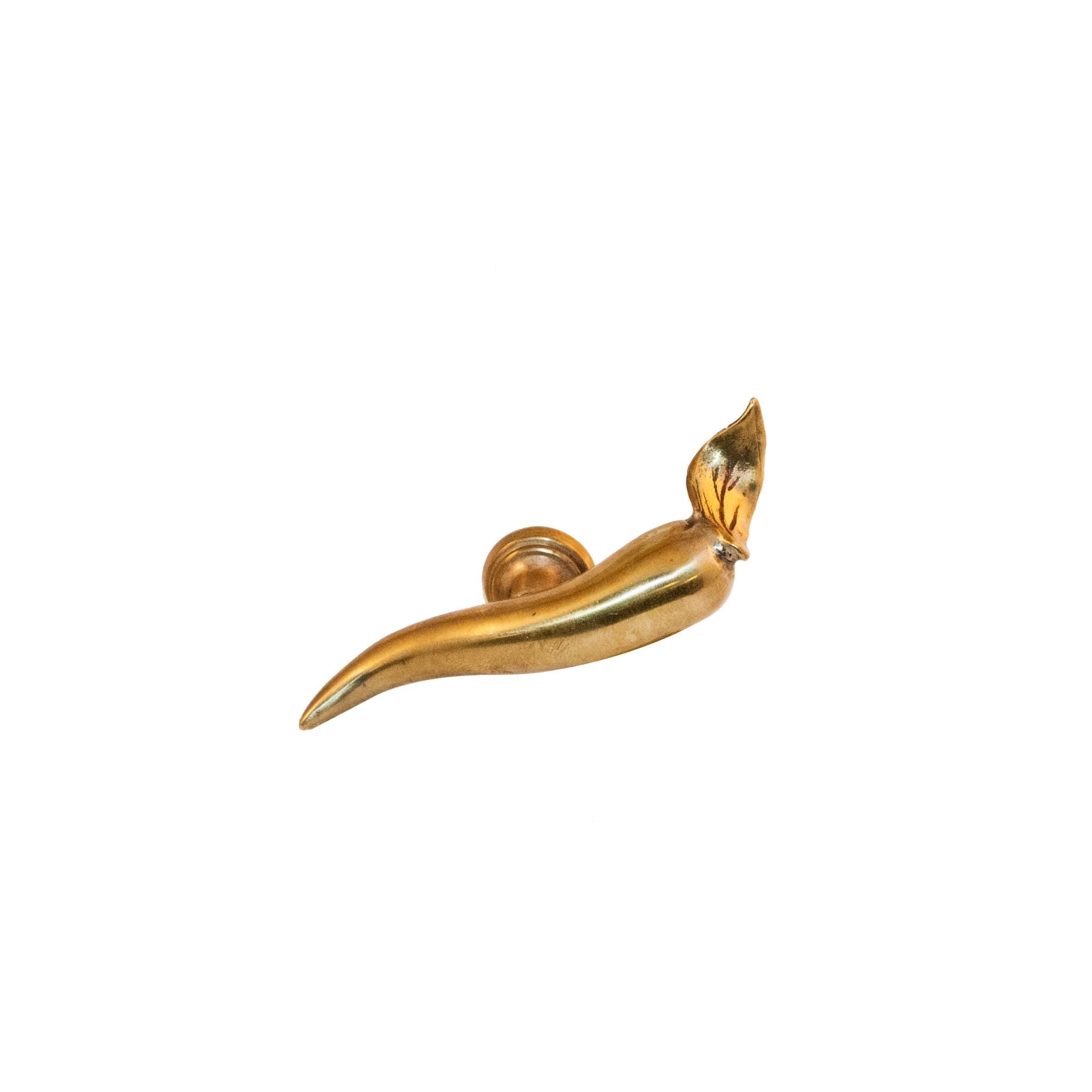An image of a brass knob shaped like a chili pepper against a neutral background. The knob features detailed contours and texture resembling a chili pepper, adding a touch of spice and personality to furniture or drawers.