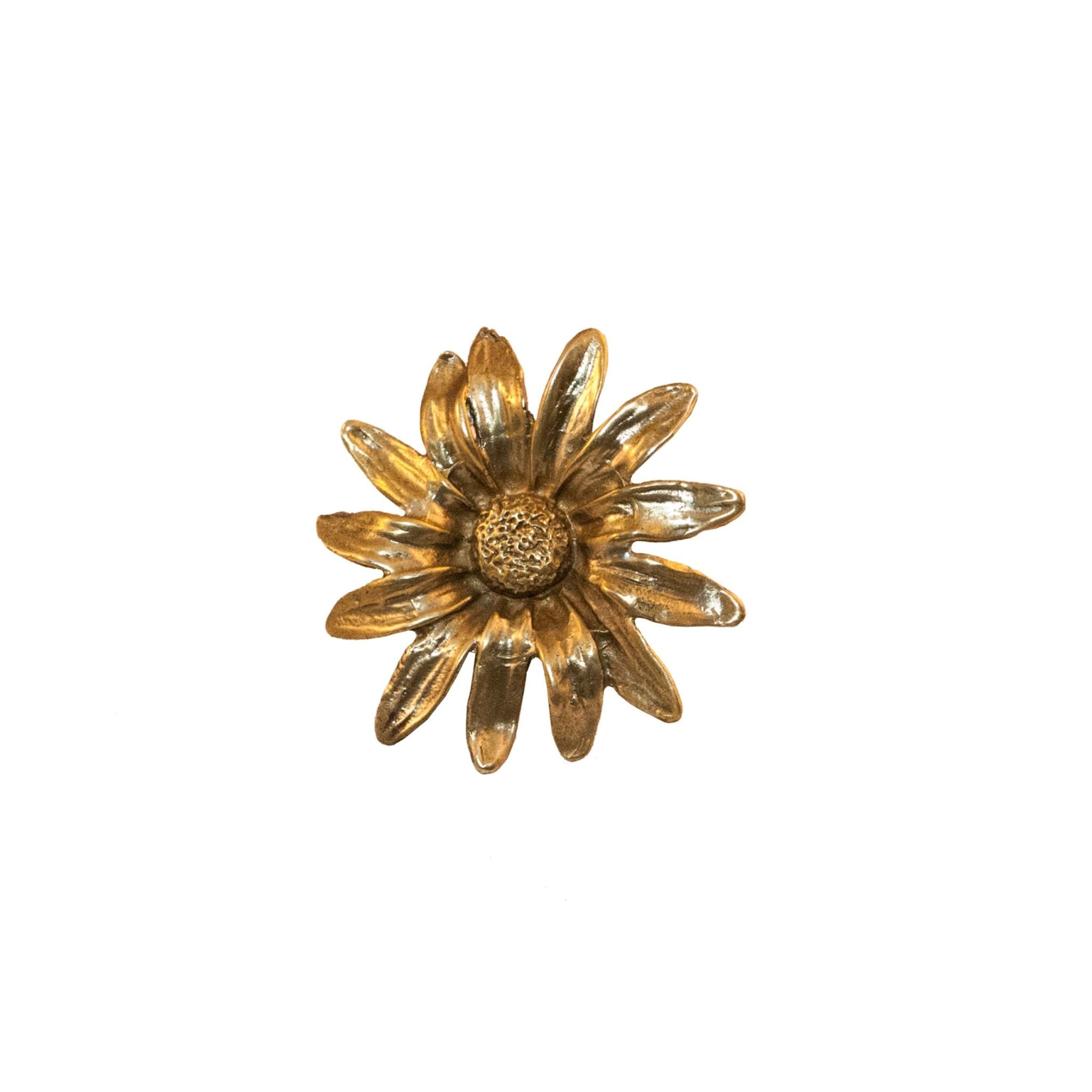 Brass daisy-shaped knob, perfect for cabinets and drawers, adds a touch of elegance to any furniture piece.