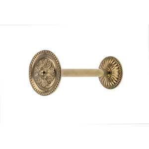 A decorative brass curtain tieback with a smooth, polished finish. It has a rounded shape that wraps securely around the curtain, with refined detailing along the surface that adds texture and an elegant touch. The brass material has a warm, classic feel, making it both a functional piece and a stylish accent for any room.