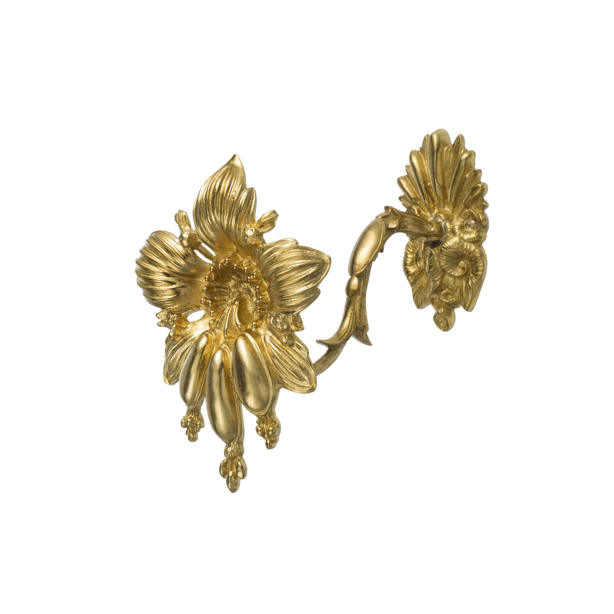 A brass curtain tieback shaped like a flower. The tieback has a smooth, polished surface with petals that form a soft, rounded flower design. Each petal is slightly curved, creating a layered and natural look that adds texture and dimension. The flower design gives a delicate, elegant touch to the tieback, making it both functional and decorative for any room.