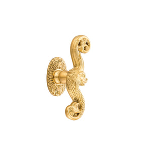 This is a brass window handle adorned with a detailed triton motif, inspired by the mythological sea god. The handle has a smooth, polished brass finish, giving it a warm, golden glow and a cool touch. The triton design is raised, providing a textured, intricate pattern that can be felt with the fingers. The handle’s ergonomic form makes it comfortable to hold and turn, combining functionality with a touch of timeless, marine-inspired elegance for refined interiors.