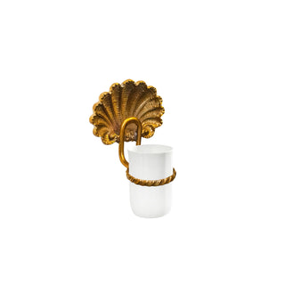 This toothbrush holder features a smooth, cylindrical ceramic body paired with a polished brass base. The brass base is decorated with a finely detailed shell motif, adding a raised and textured element for a tactile experience. The ceramic surface is sleek and seamless, providing a comfortable and secure space for holding toothbrushes. The combination of the smooth ceramic and the intricate, cool-to-the-touch brass shell detail creates a harmonious blend of elegance and coastal charm.