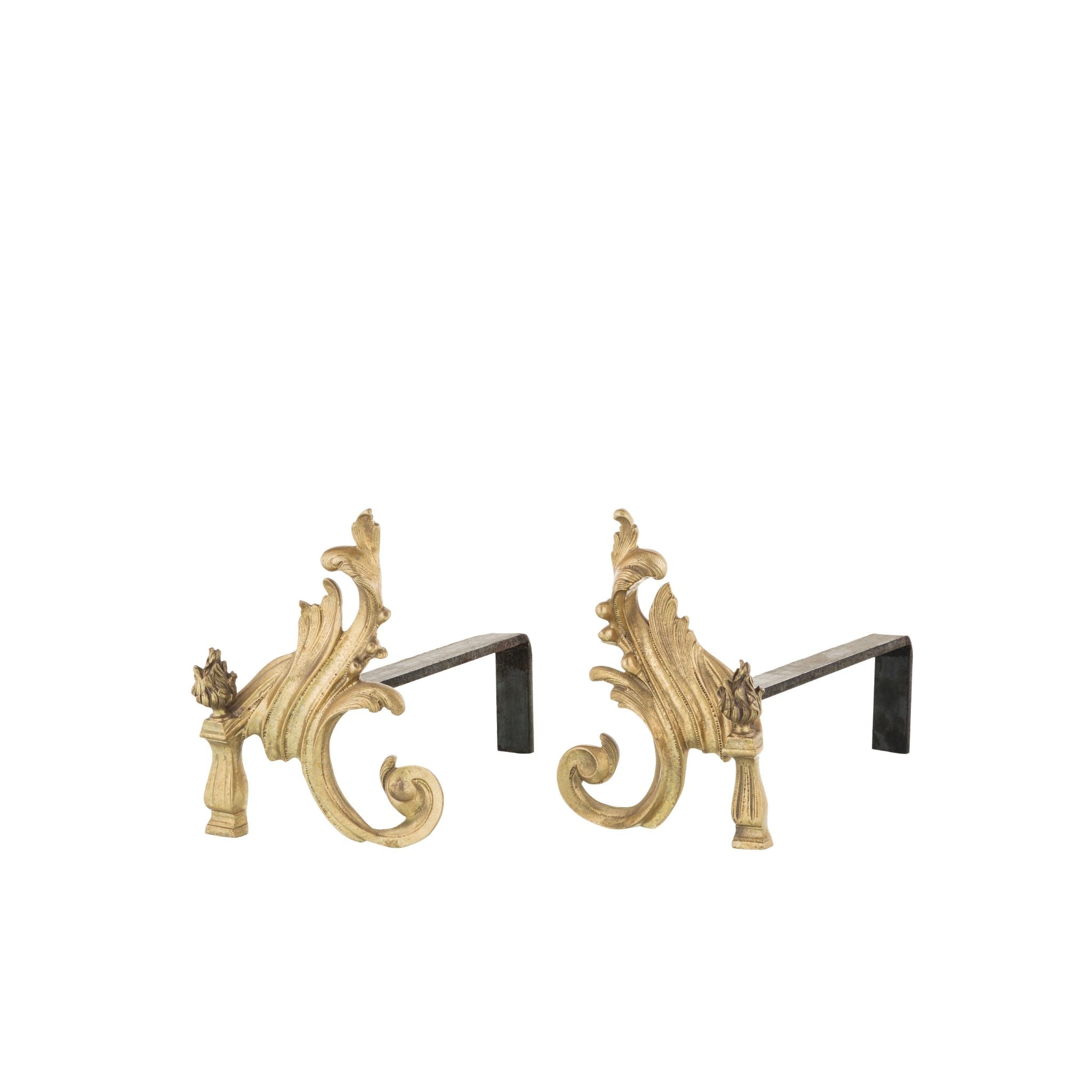 Our brass and iron flame andirons are a stunning combination of durability and elegance. Each andiron features a robust iron base for stability, topped with a decorative brass flame design that feels smooth and cool to the touch. The iron base has a textured surface, adding a tactile contrast to the polished brass accents. These andirons are designed to hold firewood securely in place, ensuring optimal airflow for a better-burning fire. The flame motif offers a classic and artistic touch.