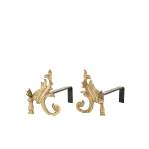 Our brass and iron flame andirons are a stunning combination of durability and elegance. Each andiron features a robust iron base for stability, topped with a decorative brass flame design that feels smooth and cool to the touch. The iron base has a textured surface, adding a tactile contrast to the polished brass accents. These andirons are designed to hold firewood securely in place, ensuring optimal airflow for a better-burning fire. The flame motif offers a classic and artistic touch.