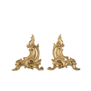 Our decorative brass and iron andirons are a harmonious blend of strength and artistry. Each andiron features a solid iron base with a slightly textured surface, ensuring stability and secure firewood support. The top is adorned with intricately crafted brass decorations, offering a smooth and polished feel. These detailed designs add a touch of elegance and a classic aesthetic to your fireplace. The andirons are both functional and ornamental.