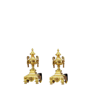 Our brass and iron andirons with urn-shaped accents are a stunning combination of functionality and elegance. The base is crafted from sturdy iron with a slightly textured surface for stability and secure firewood support. Rising from the base are polished brass urn-shaped details, smooth to the touch, offering a refined and classic aesthetic. The urn design adds a touch of timeless sophistication, making these andirons both practical for maintaining optimal airflow and decorative. 