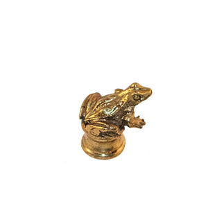 A small brass knob shaped like a frog, featuring intricate details.