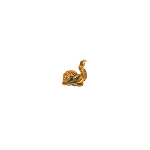 A small brass knob shaped like a snail, featuring detailed craftsmanship.