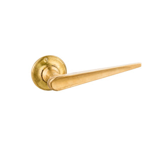 This door handle is made from solid brass with a slim, slender shape. Its streamlined design provides a comfortable grip and feels smooth to the touch. The polished brass finish has a warm, metallic feel, adding a subtle elegance to any door. This handle is ideal for those seeking a minimalist and refined look, fitting beautifully in both modern and traditional interiors.