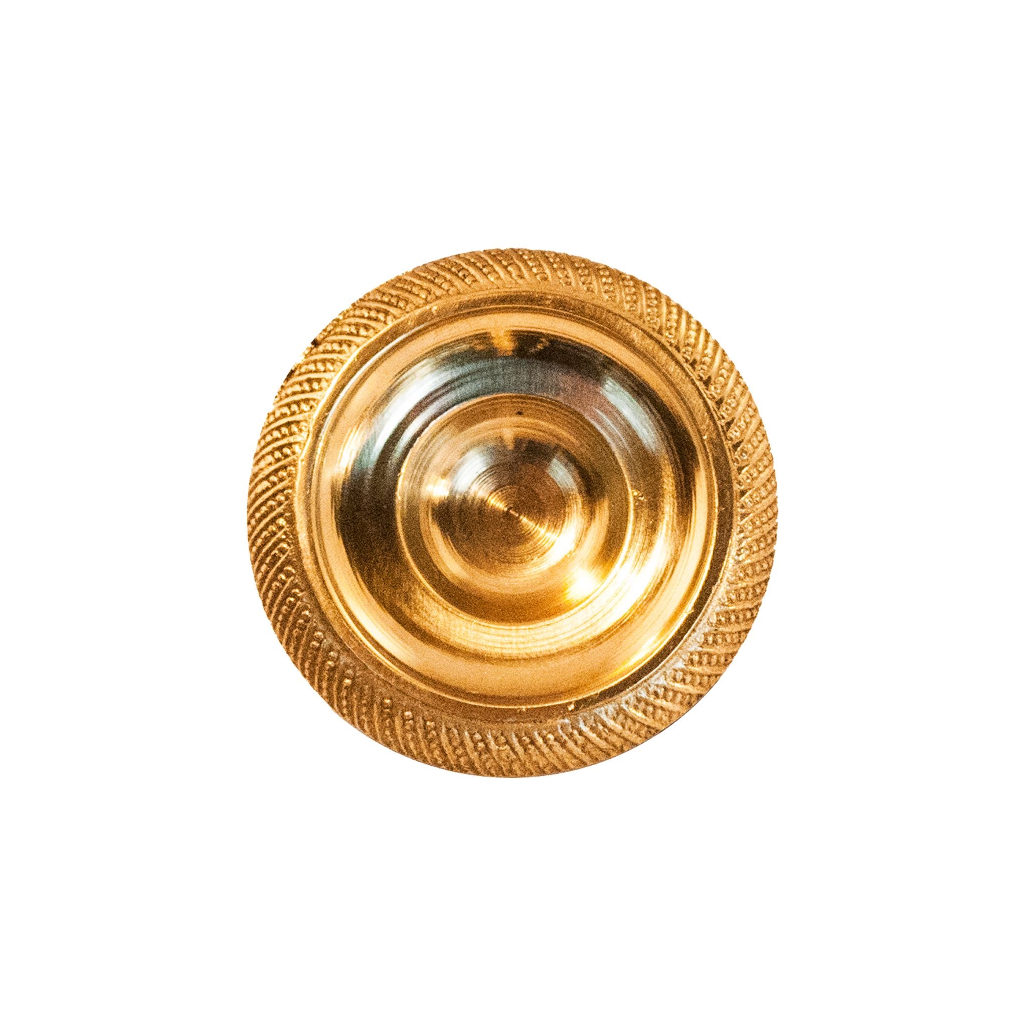 A polished, circular brass knob with intricate decorative patterns, designed for use on cabinets, drawers, and doors.