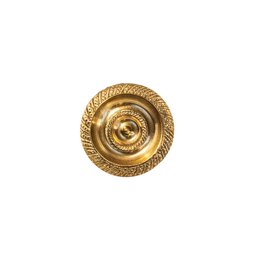 A polished, circular brass knob with intricate decorative patterns, designed for use on cabinets, drawers, and doors.