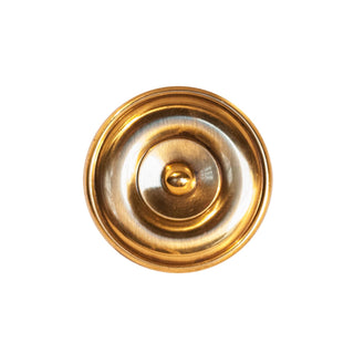 A polished circular brass knob with intricate decorative patterns, suitable for cabinets, drawers, and doors.
