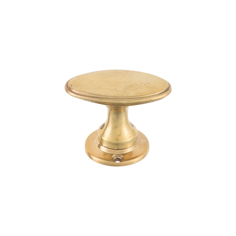 Oval brass knob with a smooth, polished finish, suitable for cabinets, drawers, and doors.