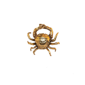 A brass knob in the shape of a crab.