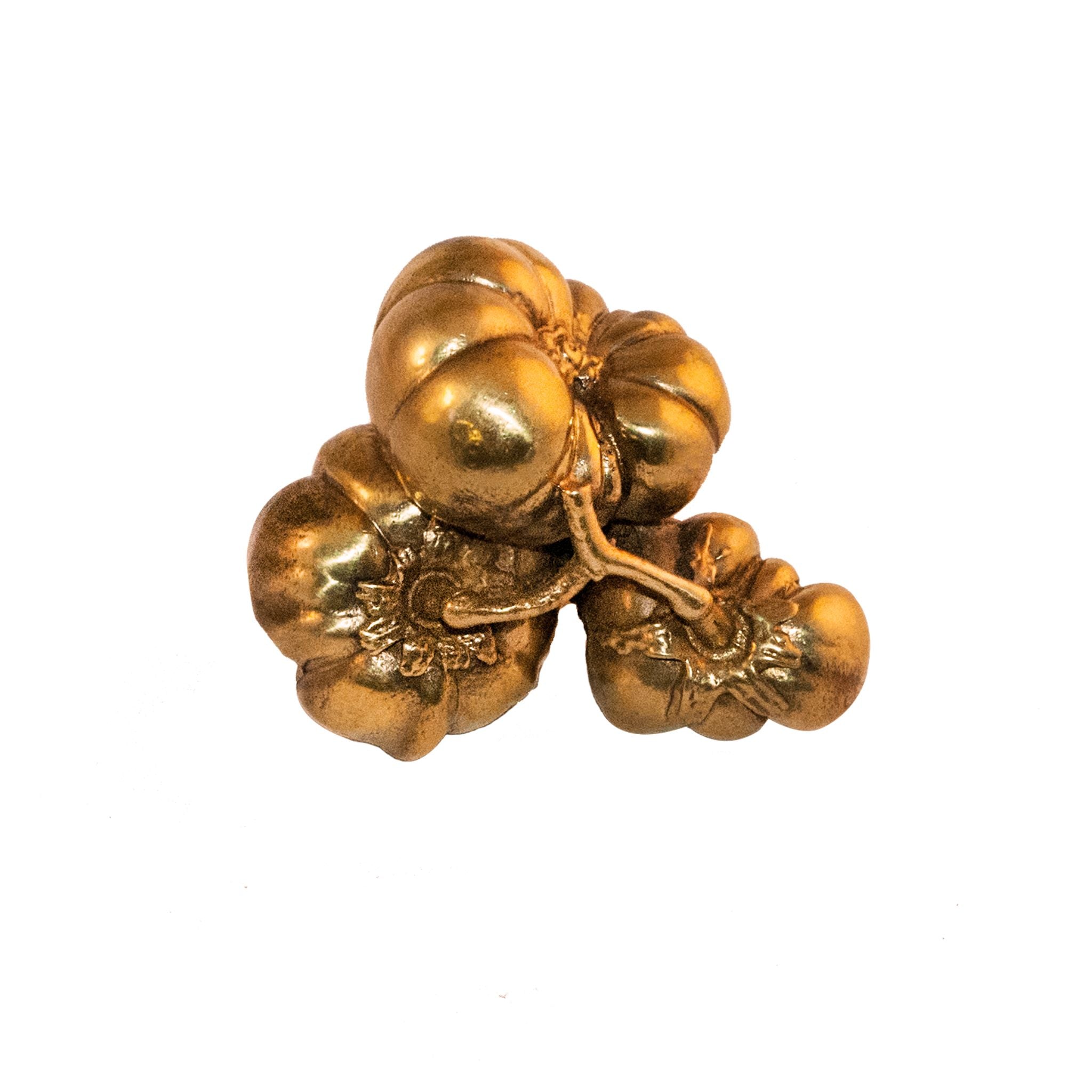 A brass knob shaped like detailed pumpkins, featuring intricate designs.