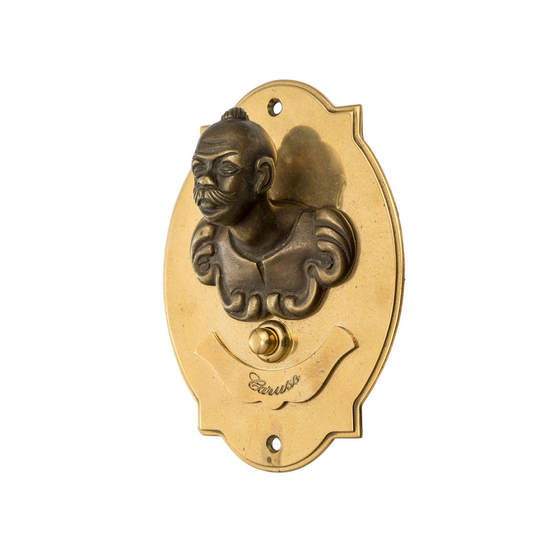 A decorative brass bell board featuring the figure of a woman. The woman is sculpted in relief, with soft, flowing lines that suggest an elegant pose—perhaps with gently curved arms and a calm facial expression. Attached to or arranged around the woman’s figure are several small brass bells. Each bell has a smooth, rounded shape, and when lightly tapped, it produces a soft, pleasant ringing sound.